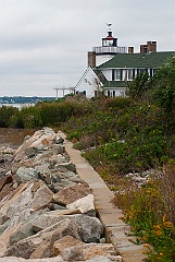Nayatt Point Lighthouse Along Stone Wall in Rhode Island